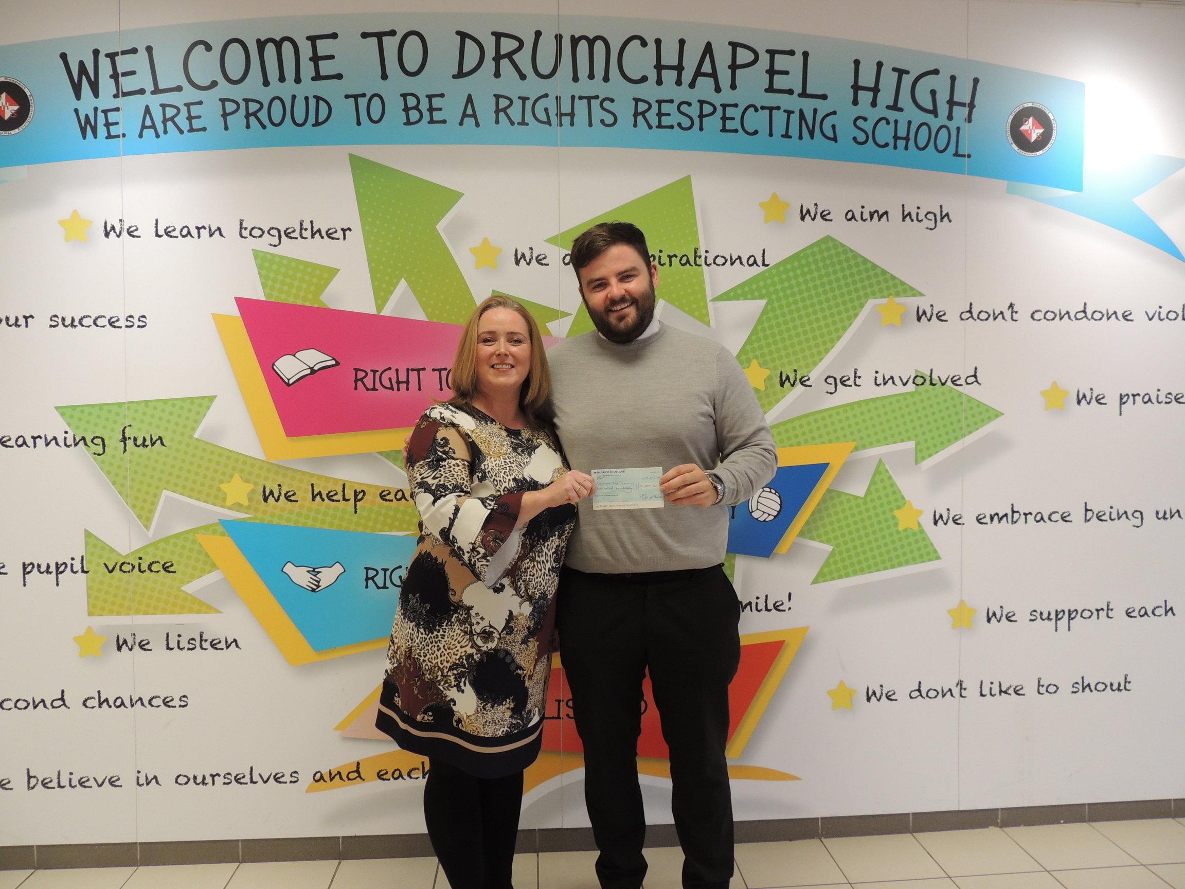Housing Officer Matthew presenting cheque to Drumchapel High School head teacher Joanne Sturgeon